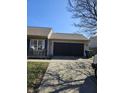 Attached garage with ample driveway space, offering convenient parking and storage solutions for homeowners at 2509 Bristlecone Dr, Indianapolis, IN 46217