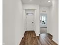 Bright entryway featuring hardwood floors, a white front door, and an open view to the living area at 260 Onset Way, Westfield, IN 46074