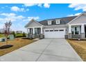 Beautiful single-Gathering home with gray siding, stone accents, two-car garage, and a concrete driveway at 260 Onset Way, Westfield, IN 46074