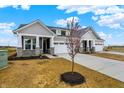 Stunning exterior view of a home with gray siding, professional landscaping, and a long concrete driveway at 260 Onset Way, Westfield, IN 46074