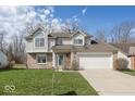 Inviting two-story home with a two-car garage, brick accents, and a well-maintained lawn at 2916 Scottsdale Dr, Indianapolis, IN 46234