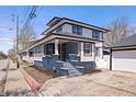 Beautiful two-story home with inviting front porch, attractive landscaping, and a private driveway with three-car garage at 2920 E 11Th St, Indianapolis, IN 46201