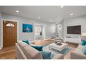 Bright living room featuring hardwood floors, recessed lighting, and comfortable seating with a view of the staircase at 2920 E 11Th St, Indianapolis, IN 46201