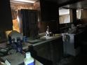 Dated kitchen with dark cabinetry, worn countertops, and miscellaneous items scattered about at 326 N Grant St, Brownsburg, IN 46112