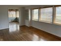 Bright living room featuring wood floors, multiple windows, and wainscotting at 3516 Circle Blvd, Indianapolis, IN 46220