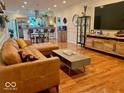Open living space with leather sofa, hardwood floors and modern finishes at 3535 Birchwood Ave, Indianapolis, IN 46205
