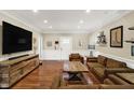 Spacious living room features beautiful hardwood floors, comfortable seating, and natural light at 3535 Birchwood Ave, Indianapolis, IN 46205