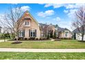 Beautiful home with a well-manicured lawn, elegant brickwork, and lush landscaping in a peaceful neighborhood at 3629 Pete Dye Blvd, Carmel, IN 46033