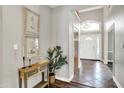 Bright foyer with elegant decor and hardwood flooring, leading to the rest of the home at 3862 Penzance Pl, Carmel, IN 46032