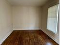 A cozy room with hardwood floors and natural light streaming through the window at 418 N Drexel Ave, Indianapolis, IN 46201