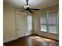 Bedroom featuring hardwood floors, two windows with blinds, ceiling fan and closet at 418 N Drexel Ave, Indianapolis, IN 46201