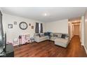 Cozy living room boasts hardwood floors and ample space for relaxation and entertaining at 4414 Lexington Ave, Indianapolis, IN 46203