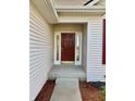 Well-lit front entrance with red door, sidelights, and a concrete porch at 4414 Princeton Park Dr, Columbus, IN 47201