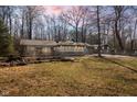 A charming single story home features a sunroom and a blue attached garage, surrounded by bare trees at 4631 Berkshire Ln, Indianapolis, IN 46226