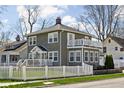 Attractive home exterior featuring a fenced yard and second story balcony at 4850 Guilford Ave, Indianapolis, IN 46205
