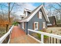 Charming log cabin style home featuring a red-stained deck and white railings, blending rustic appeal with modern design at 6517 Chipmunk Ct, Nineveh, IN 46164