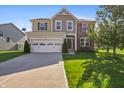 Lovely home with a beautiful lawn, two car garage and a nice tree in the front yard at 6615 School Branch Dr, Brownsburg, IN 46112