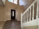 Inviting foyer with soaring ceilings, wood floors, and a staircase creates a grand entrance at 7130 English Birch Ln, Indianapolis, IN 46268