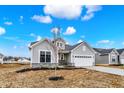 Craftsman-style home with a well-manicured lawn, attached two car garage, and inviting front porch at 7170 Rose Hill Ave, Brownsburg, IN 46112