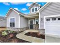 Inviting front entry with a cozy porch, stone accents, and a beautifully designed walkway at 7170 Rose Hill Ave, Brownsburg, IN 46112
