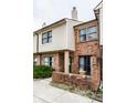 Townhome showing a mix of brick and siding, with a cozy brick-enclosed patio area at 9449 Maple Way, Indianapolis, IN 46268