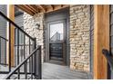 Apartment front door entrance with stone siding and black metal stair railings at 102 Clarendon Dr # 514, Noblesville, IN 46062