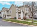 Townhouse exterior showcasing a two-car garage, neutral siding, and well-manicured lawn at 1160 Falcon Rdg, Carmel, IN 46280