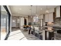 Modern kitchen with a large island, stainless steel appliances, and hardwood floors at 13395 Vickery Ridge Dr, Fishers, IN 46037