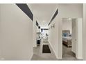 Modern hallway features stylish decor leading to a bedroom with a comfortable bed at 1347 Shaw Ln, Shelbyville, IN 46176