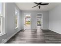 Bright living room featuring new gray vinyl plank flooring, fresh paint, and abundant natural light at 1426 S Talbott St, Indianapolis, IN 46225
