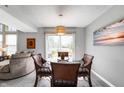 Inviting dining room with a modern glass table, wicker chairs, and a view of the backyard at 1568 Brookfield Cir, Franklin, IN 46131