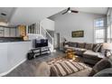 Open-concept living area with a cozy sofa, large windows, and easy access to the staircase and kitchen at 1568 Brookfield Cir, Franklin, IN 46131