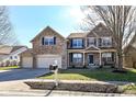 Charming two-story home with stone facade, well-manicured lawn, and a convenient three-car garage at 15898 Bounds Dr, Noblesville, IN 46062