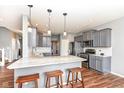Modern kitchen with granite countertops, stainless steel appliances, and wooden bar stools at 15898 Bounds Dr, Noblesville, IN 46062