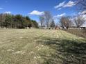 Expansive open grassy acreage with blue skies and scattered trees at 17245 N 200 E, Summitville, IN 46070
