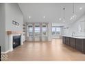 Spacious living room with high ceilings, fireplace, and large windows offering plenty of natural light at 19036 Karyn Ln, Noblesville, IN 46062