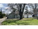 View of a single-story home with light green siding and an unkept front yard at 1904 S Rosemont Ave, Muncie, IN 47302