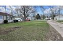 Street view of a neighborhood with green lawns, mature trees, and a mix of single-story homes at 1904 S Rosemont Ave, Muncie, IN 47302