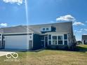 Inviting single-story home boasting a two-car garage, manicured lawn, and beautiful landscaping on a clear day at 19350 Goins Blvd, Westfield, IN 46074