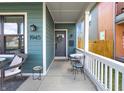 Cozy front porch featuring seating, a wreath, and a 'Hello' welcome mat by the front door at 1945 Carrollton Ave, Indianapolis, IN 46202