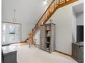 Inviting foyer with staircase, hardwood floors, and a rocking chair lending a homey feel at 2054 Partridge Dr, Franklin, IN 46131