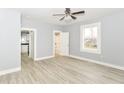 Bright bedroom featuring wood floors, a ceiling fan, and access to bath and kitchen at 209 Pennsylvania St, Shirley, IN 47384