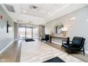 A bright lobby area with an outside view, a round mirror and black chairs at 20971 Shoreline Ct # 309, Noblesville, IN 46062