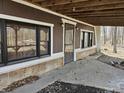Exterior view of home showing access to the crawlspace and an outdoor living space at 21977 Craig Ave, Noblesville, IN 46060