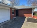 The home's entrance is accessible from the concrete walkway leading from the driveway to the front door at 2309 Dover St, Anderson, IN 46013
