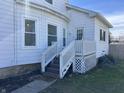 Quaint home exterior featuring a small porch with white railings and steps at 238 S Main St, Wilkinson, IN 46186