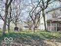 Fenced backyard with mature trees and a building in the back at 2505 E 17Th St, Indianapolis, IN 46218