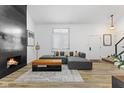 Open living room with fireplace, recessed lighting, gray couch, light colored flooring, and bright natural light at 310 E St Clair St, Indianapolis, IN 46202