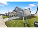 Attractive single-Gathering home with a manicured lawn, two-car garage, and inviting curb appeal on a sunny day at 3121 Arkle Rd, Westfield, IN 46074