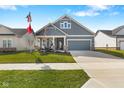 Inviting single-Gathering home with a well-maintained lawn, American flag, and a cozy front porch area at 3121 Arkle Rd, Westfield, IN 46074